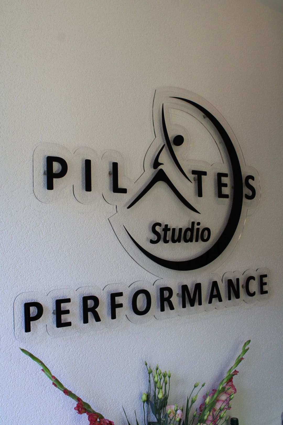 Znak Pilates Studio Performance na zidu studija